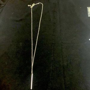 Silver necklace with strait bar pendant.